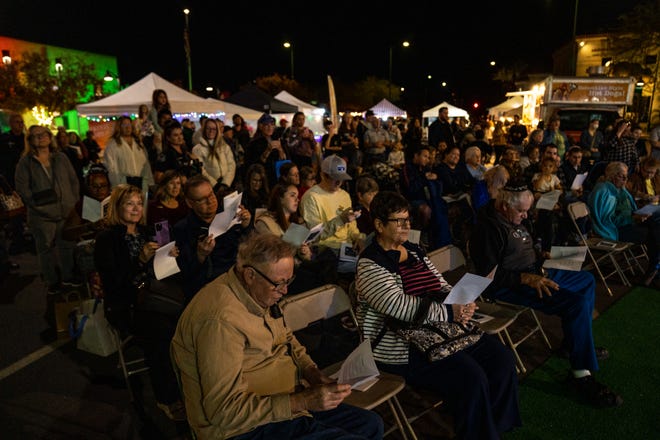 People attend a menorah lighting ceremony in Mesa on Dec. 7, 2023.