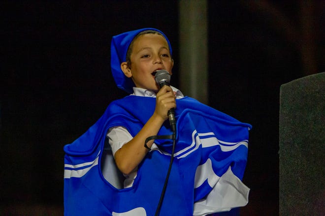 Rabbi Shmuel's son, Levi Tiechtel, sings Chanukah songs at downtown Tempe's Menorah lightning on Dec. 7, 2023.