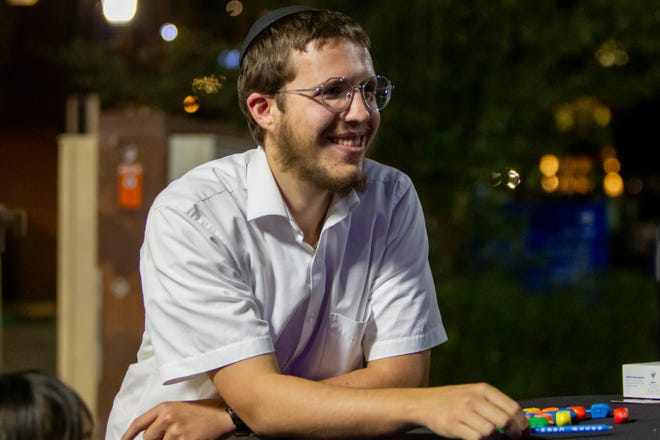 Levi Tiechtel, nephew of Rabbi Shmuel Tiechtel, watches downtown Tempe's Menorah lightning on Dec. 7, 2023.