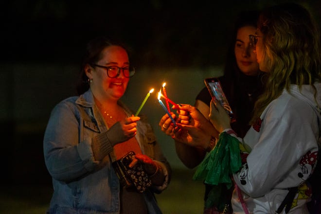 Attendees light up candles at downtown Tempe's Menorah lightning on Dec. 7, 2023.