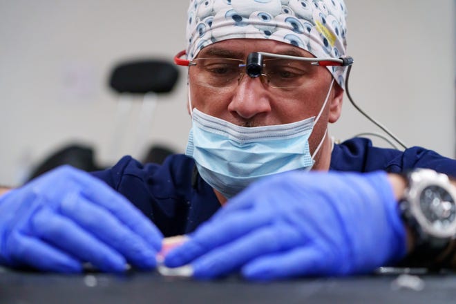 Dental technician, Damir Zega molds a set of dentures for a patient during the Arizona Dental Mission of Mercy at the Veterans Memorial Coliseum at the Arizona State Fairgrounds on Dec. 8, 2023, in Phoenix.