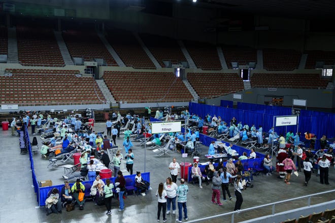 People receive free dental care at the annual Arizona Dental Mission of Mercy at the Veterans Memorial Coliseum on Dec. 8, 2023, in Phoenix.