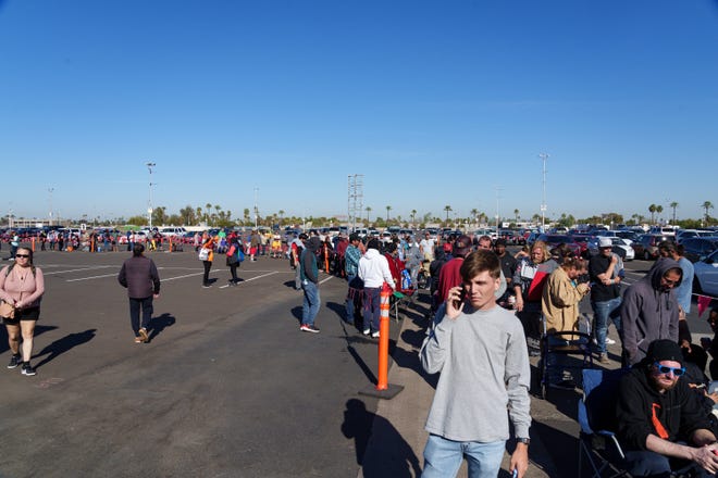 People line up outside the Veterans Memorial Coliseum to receive free dental care at the Arizona Dental Mission of Mercy at the Arizona State Fairgrounds on Dec. 8, 2023, in Phoenix.