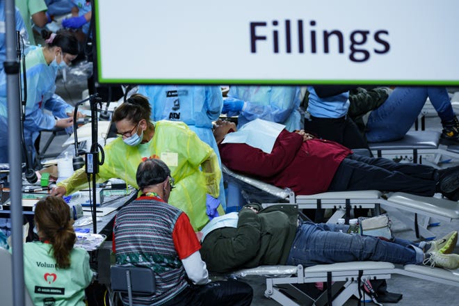 Patients receive free of charge fillings at the annual Arizona Dental Mission of Mercy at the Veterans Memorial Coliseum on Dec. 8, 2023, in Phoenix.