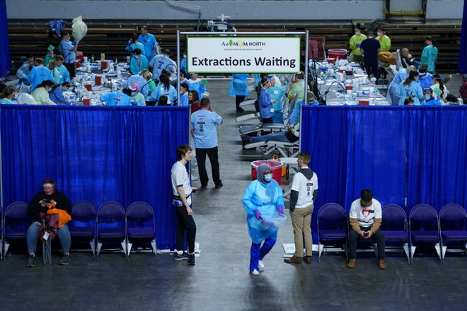 People receive free extractions at the annual Arizona Dental Mission of Mercy at the Veterans Memorial Coliseum on Dec. 8, 2023, in Phoenix.