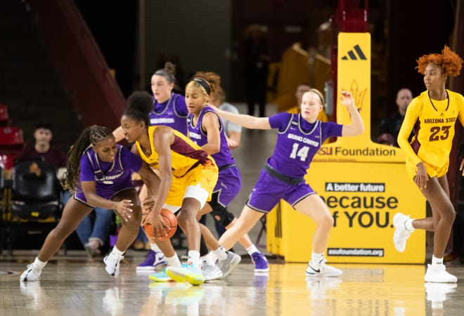 Arizona State University guard Jaddan Simmons (2) and Grand Canyon University guard Callie Cooper (0) battle for the ball at Desert Financial Arena on Dec. 8, 2023.