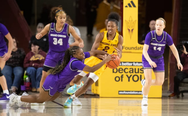 Arizona State University guard Jaddan Simmons (2) and Grand Canyon University guard Callie Cooper (0) battle for the ball at Desert Financial Arena on Dec. 8, 2023.